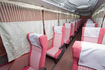 Privacy curtains between seats inside a long distance bus