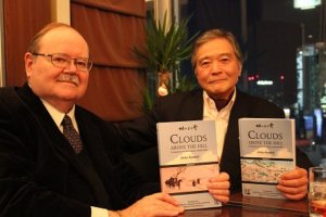 Sumio Saito (right), holding the book, poses with Paul McCarthy