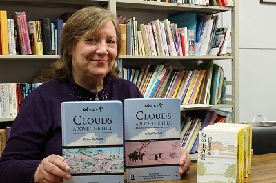 Juliet Winters Carpenter poses with Volumes 1 and 2.