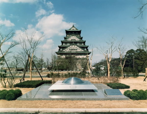 Time Capsule burial site and its monument, backed by the towering donjon of Osaka Castle.